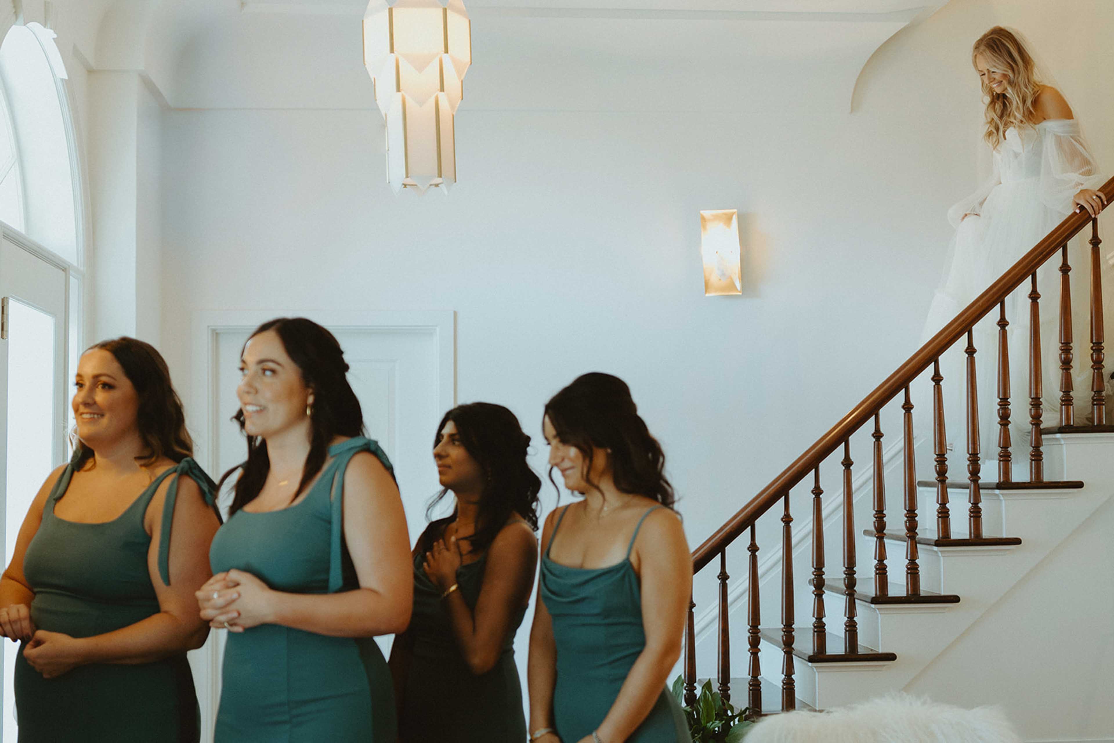 The Elm Estate Bride walking down the staris to show bridesmaids her dress