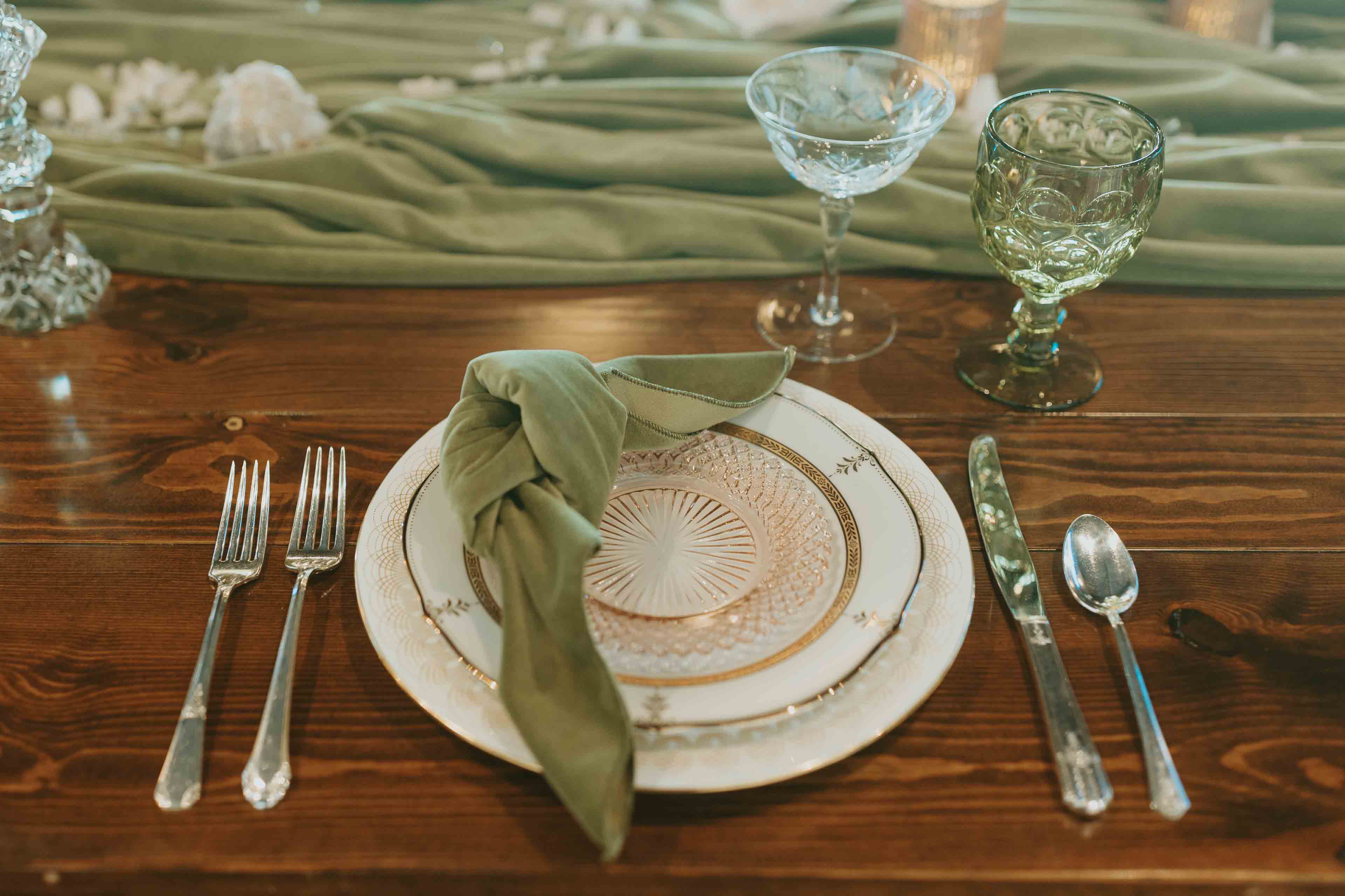 The Elm Estate Wooden table with talbe setting and green accent colors