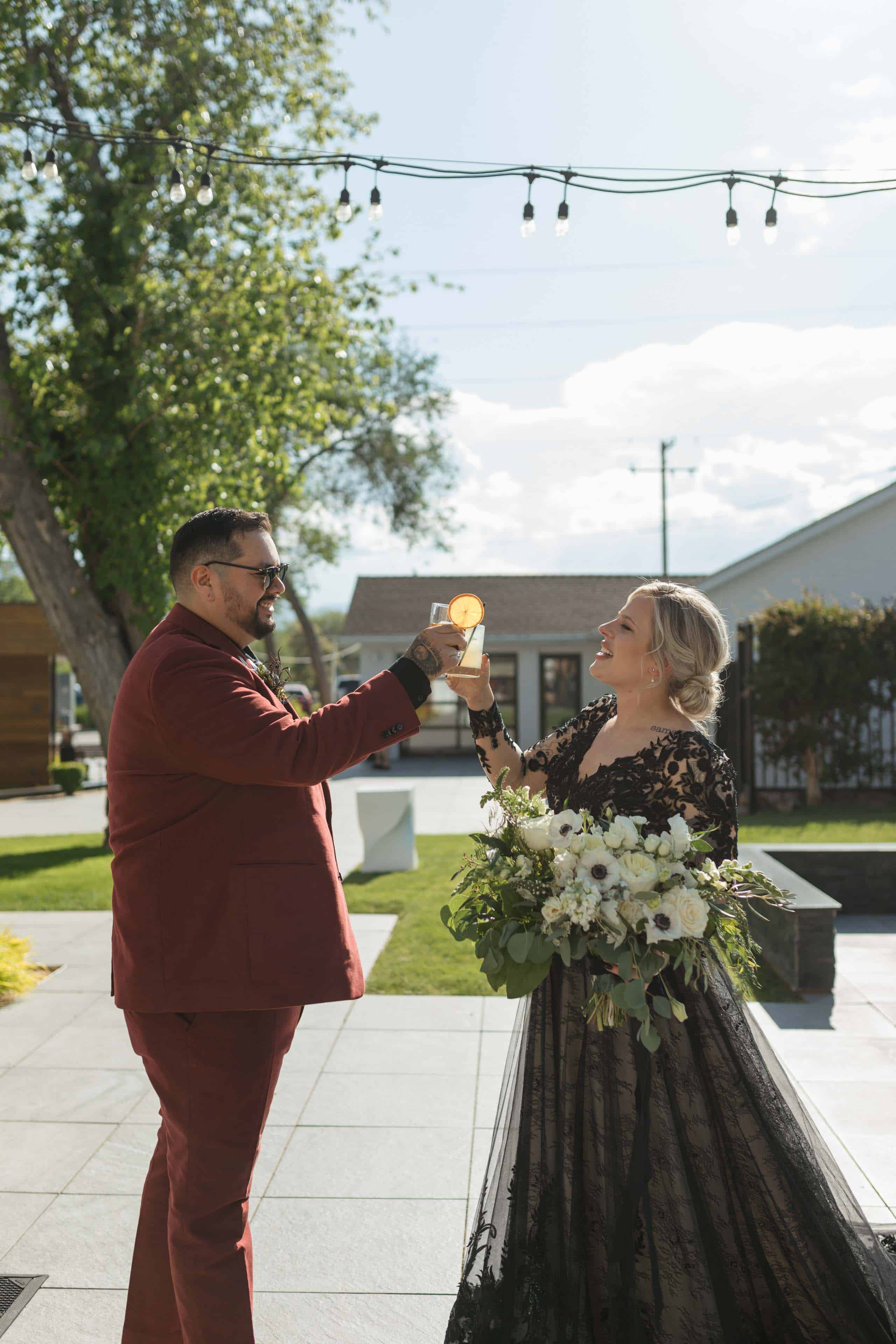 bride and groom cheersing signature cocktails after wedding ceremony