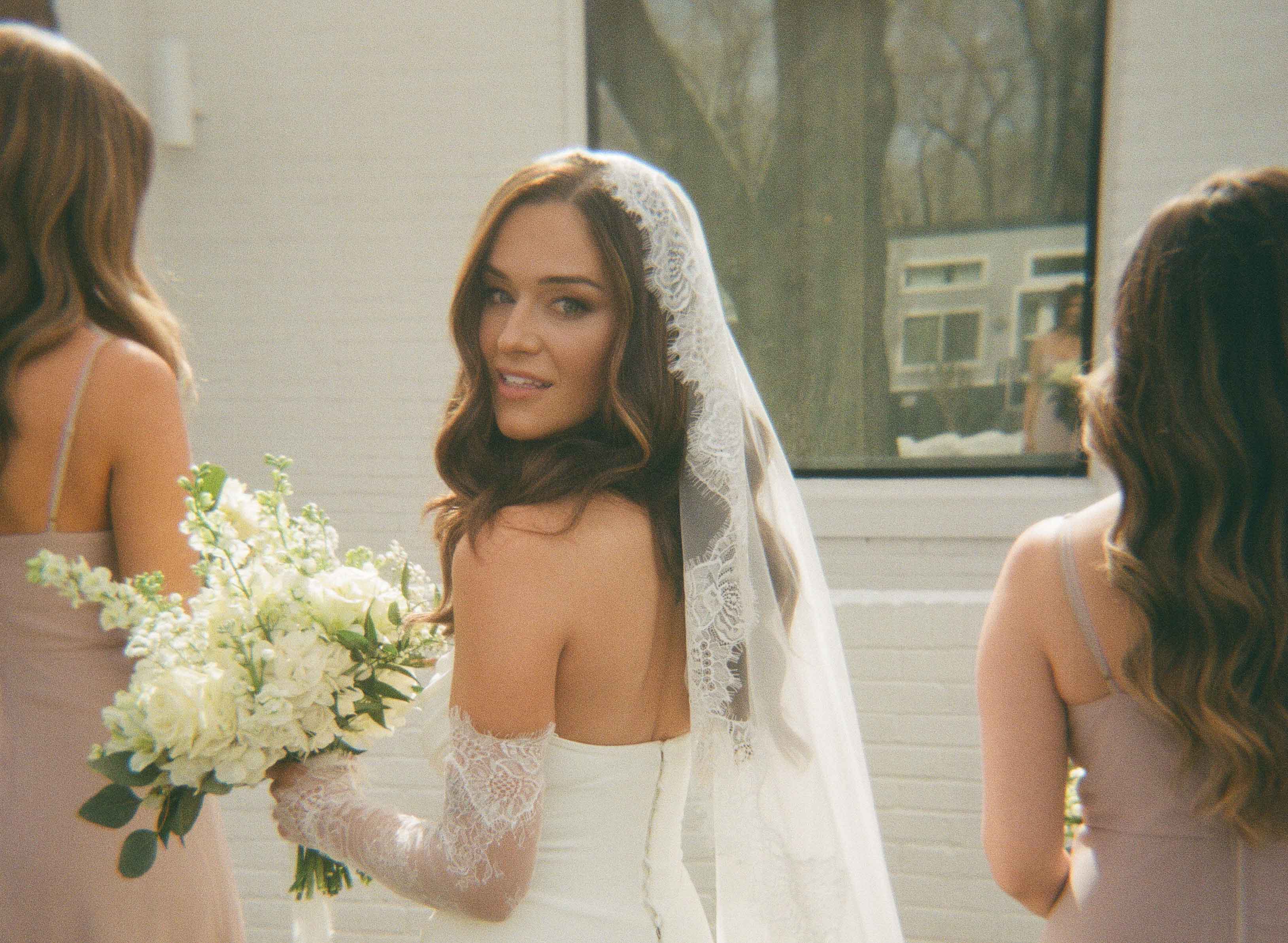 Bride holding a bouquet and smiling