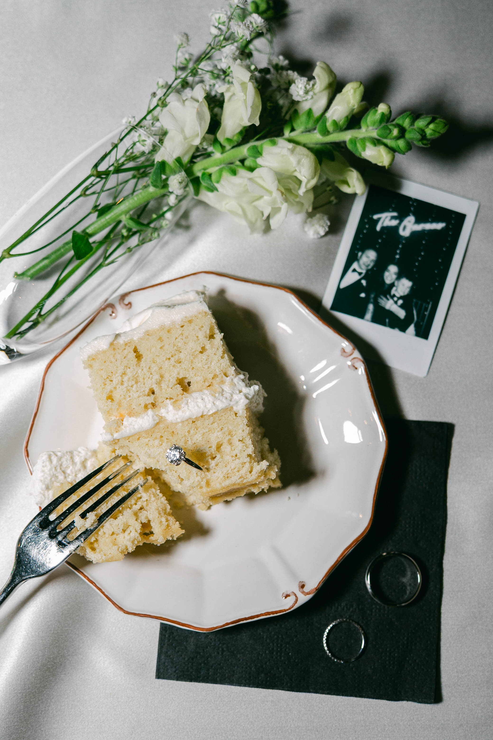 Flatlay of wedding cake photos and decorations from a wedding